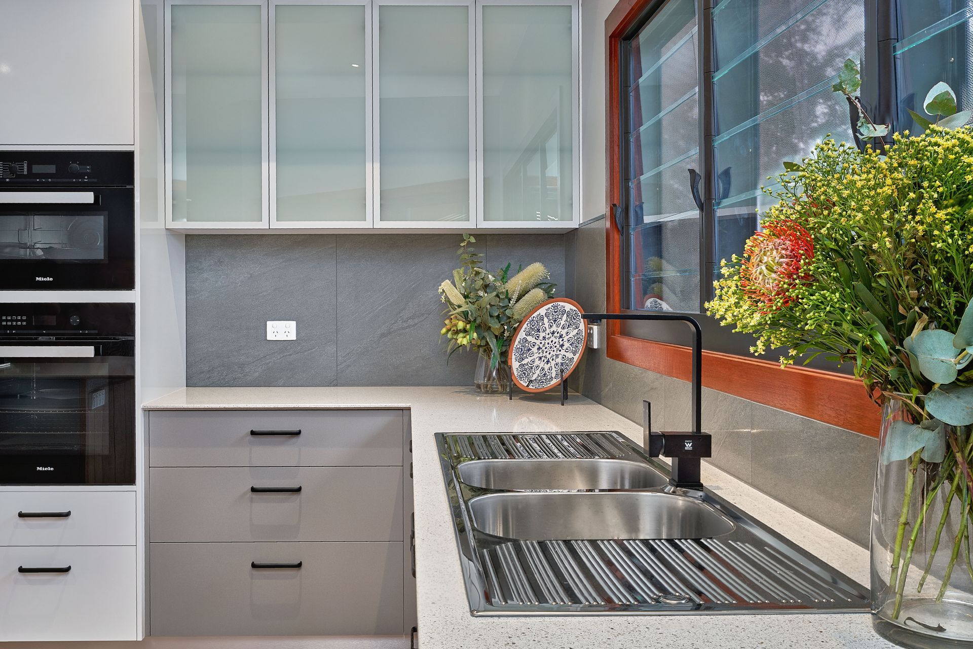A Kitchen With A Sink And Cupboards — ROGA Build Solutions in Atherton, QLD