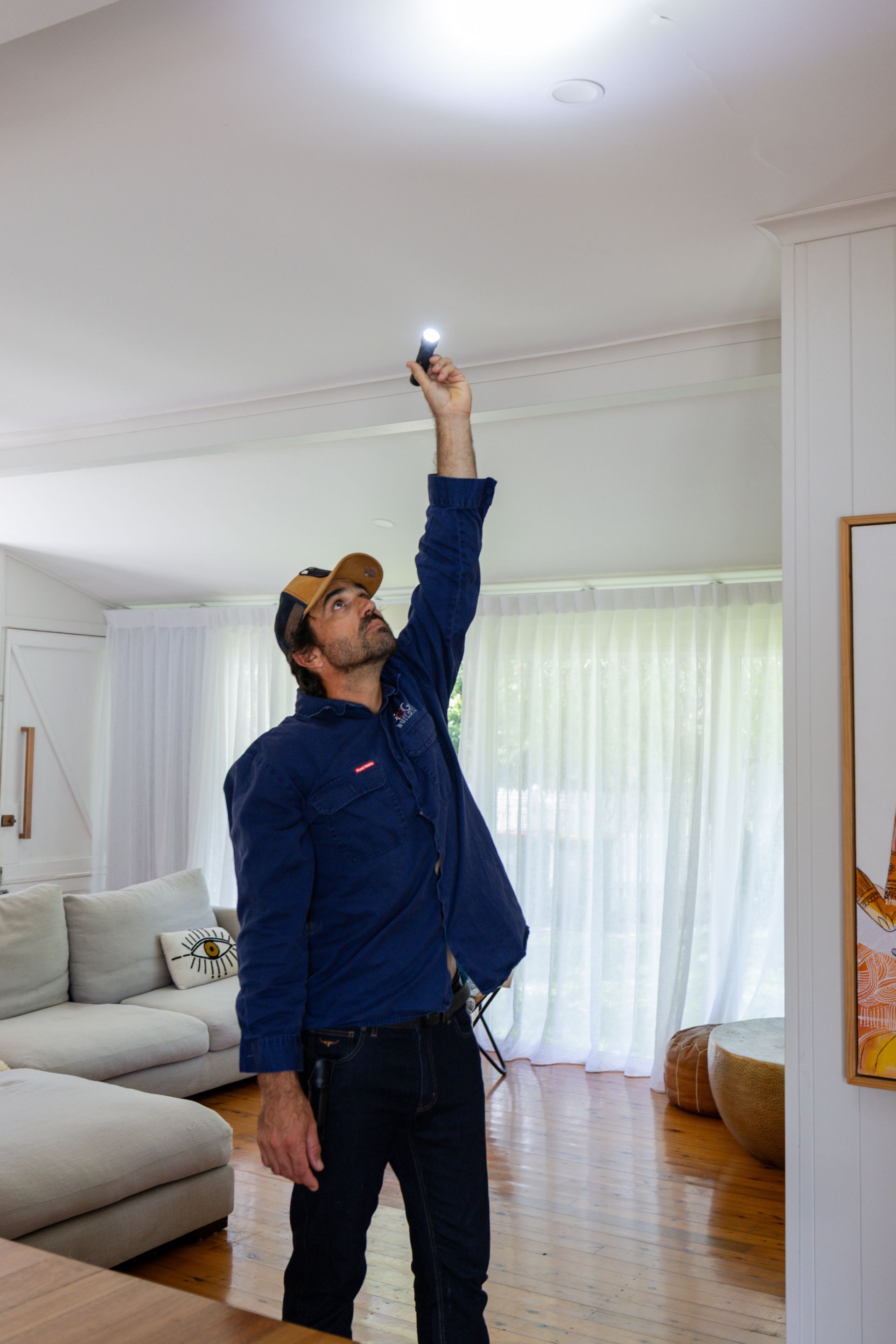 A Bedroom With a Bed, Nightstand, Lamps and Two Windows — ROGA Build Solutions in Atherton, QLD