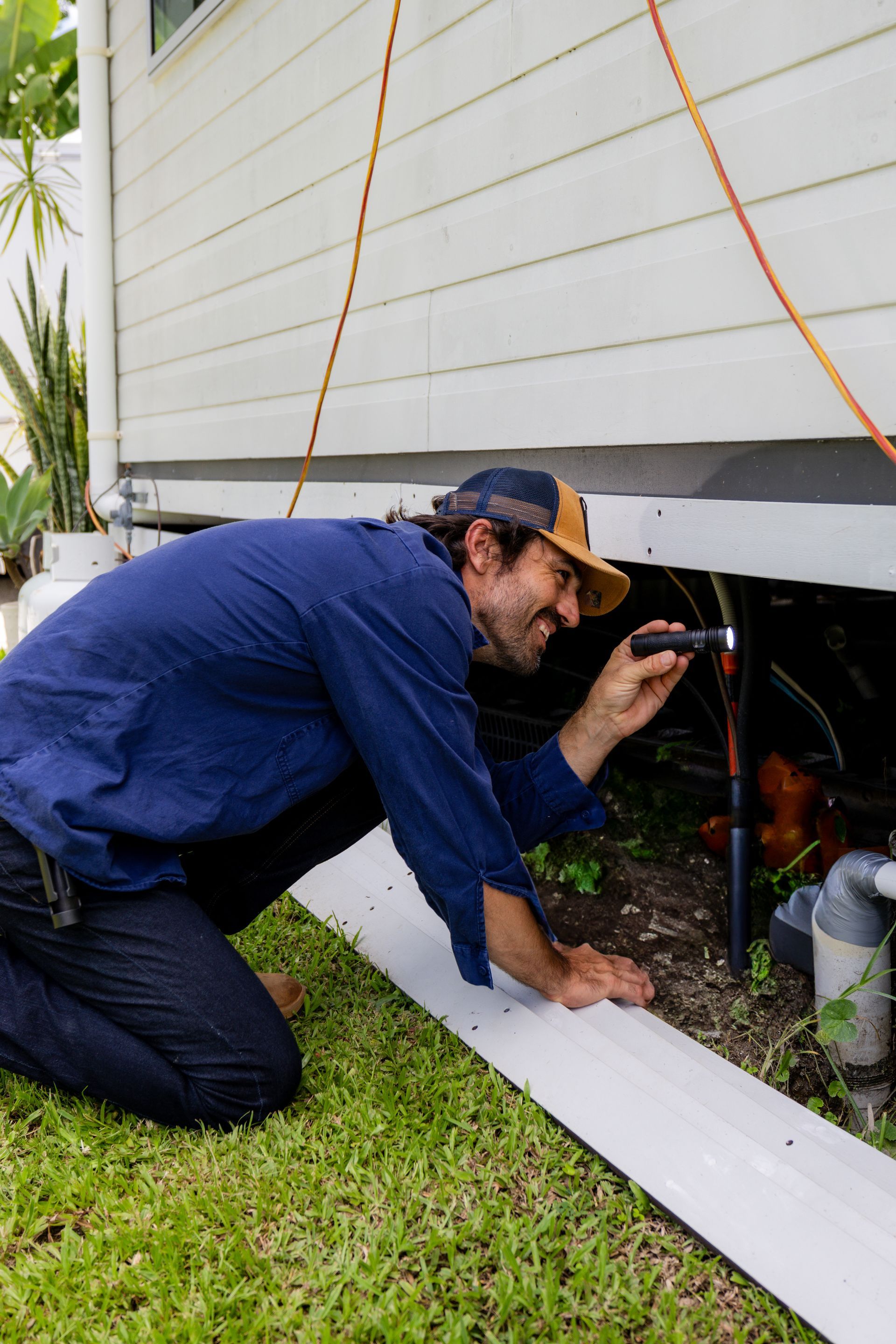 A Man Is Testing A Wall With A Monitor — ROGA Build Solutions in Atherton, QLD