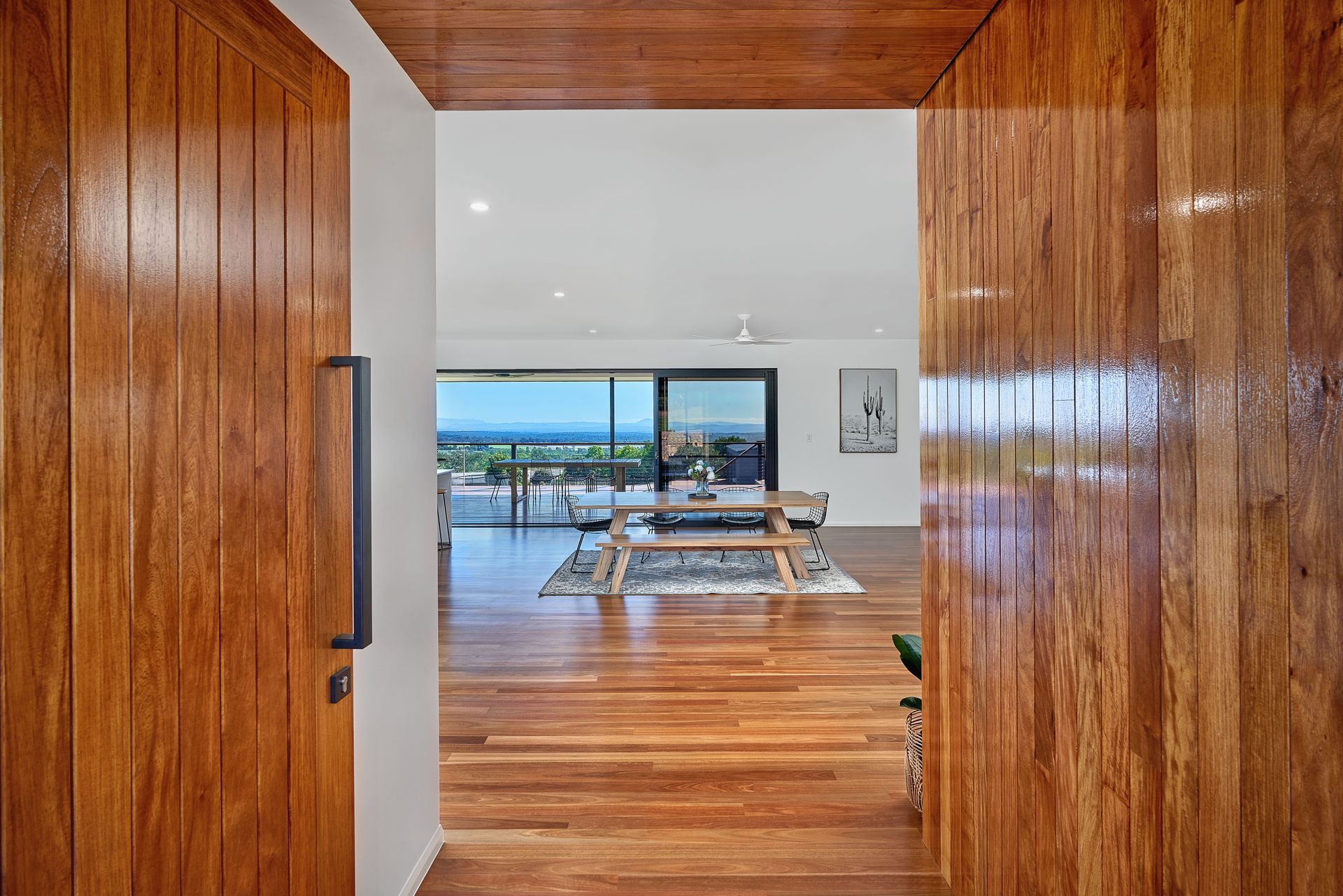 A Living Room With A Wooden Hallway — ROGA Build Solutions in Atherton, QLD