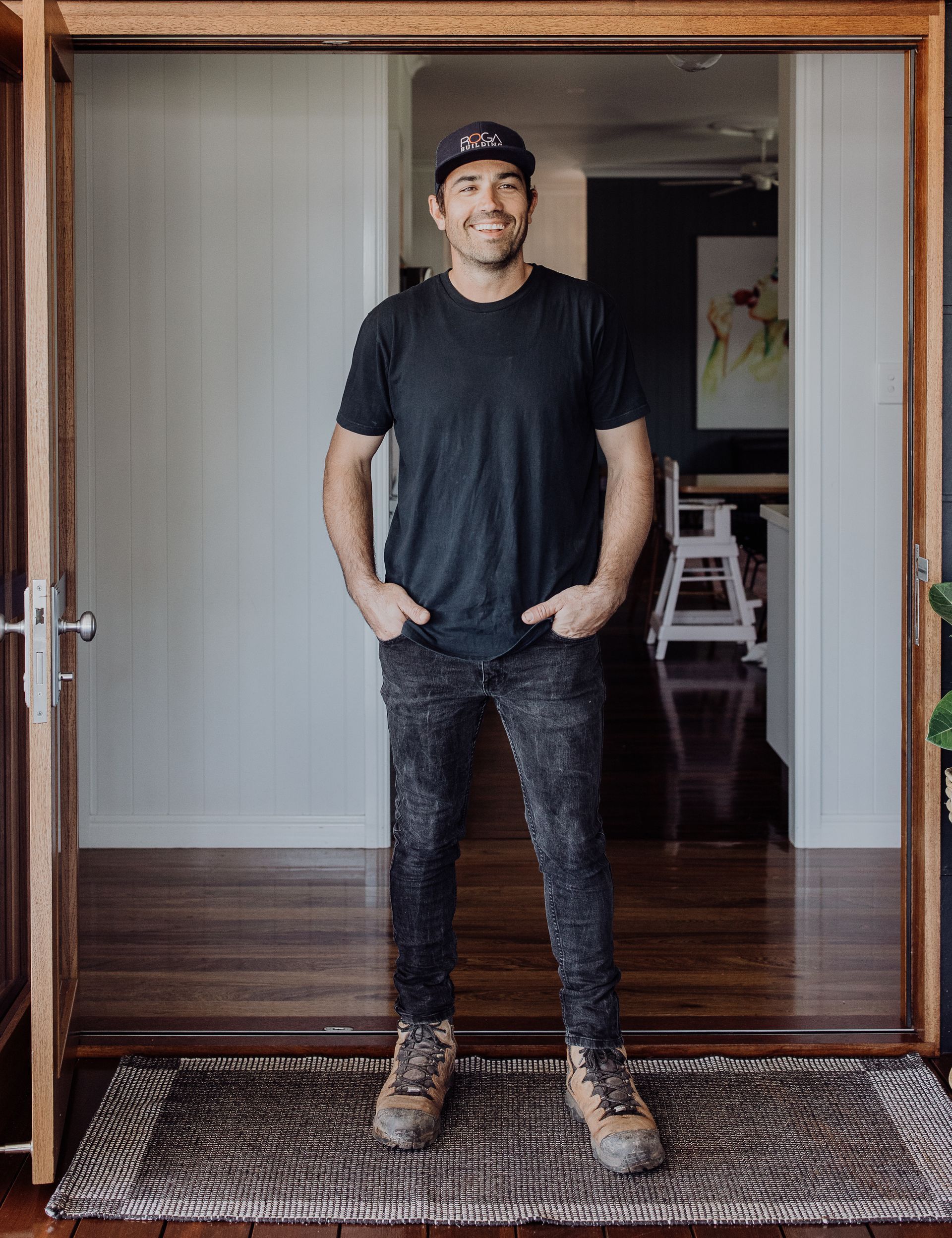A Man Is Posing For A Photo With His Hands In His Pockets — ROGA Build Solutions in Atherton, QLD