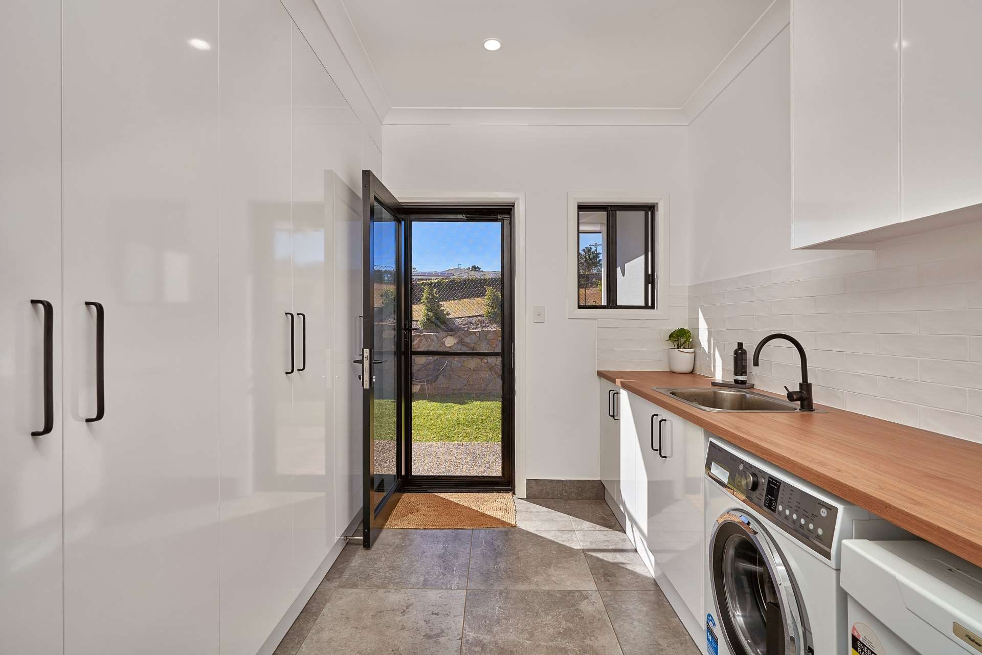 A Laundry With a Washing Machine — ROGA Build Solutions in Atherton, QLD