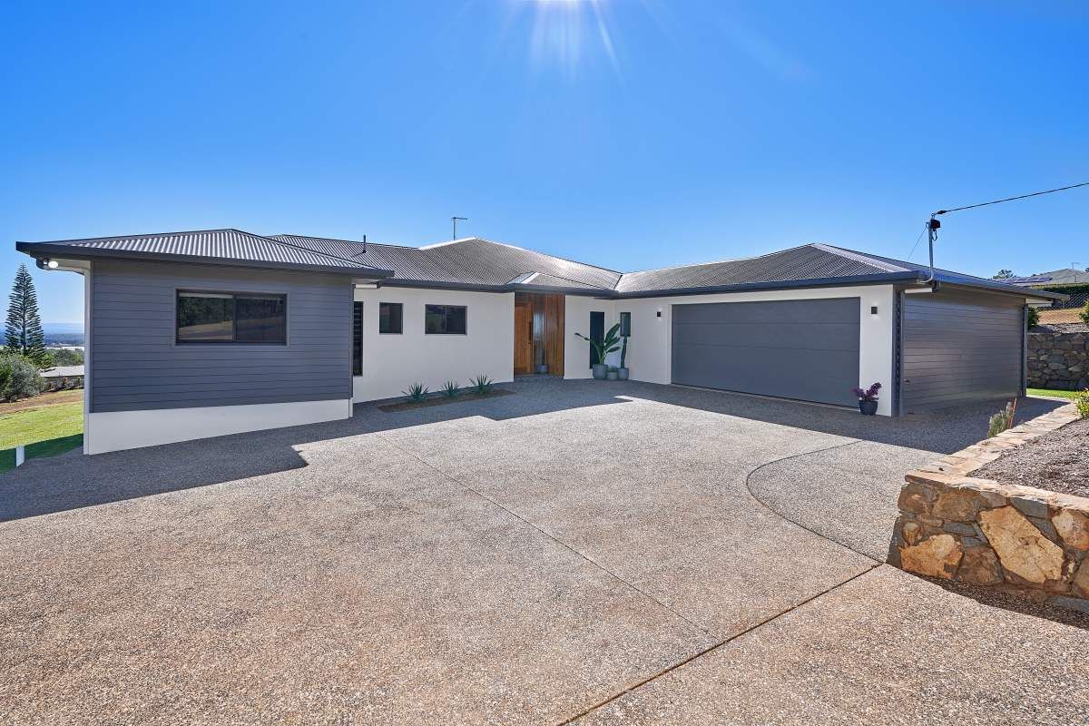 A Large House With Two Garages and a Driveway in Front of It — ROGA Build Solutions in Atherton, QLD