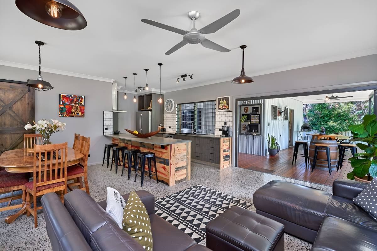 A Living Room And Kitchen With A Ceiling Fan — ROGA Build Solutions in Atherton, QLD