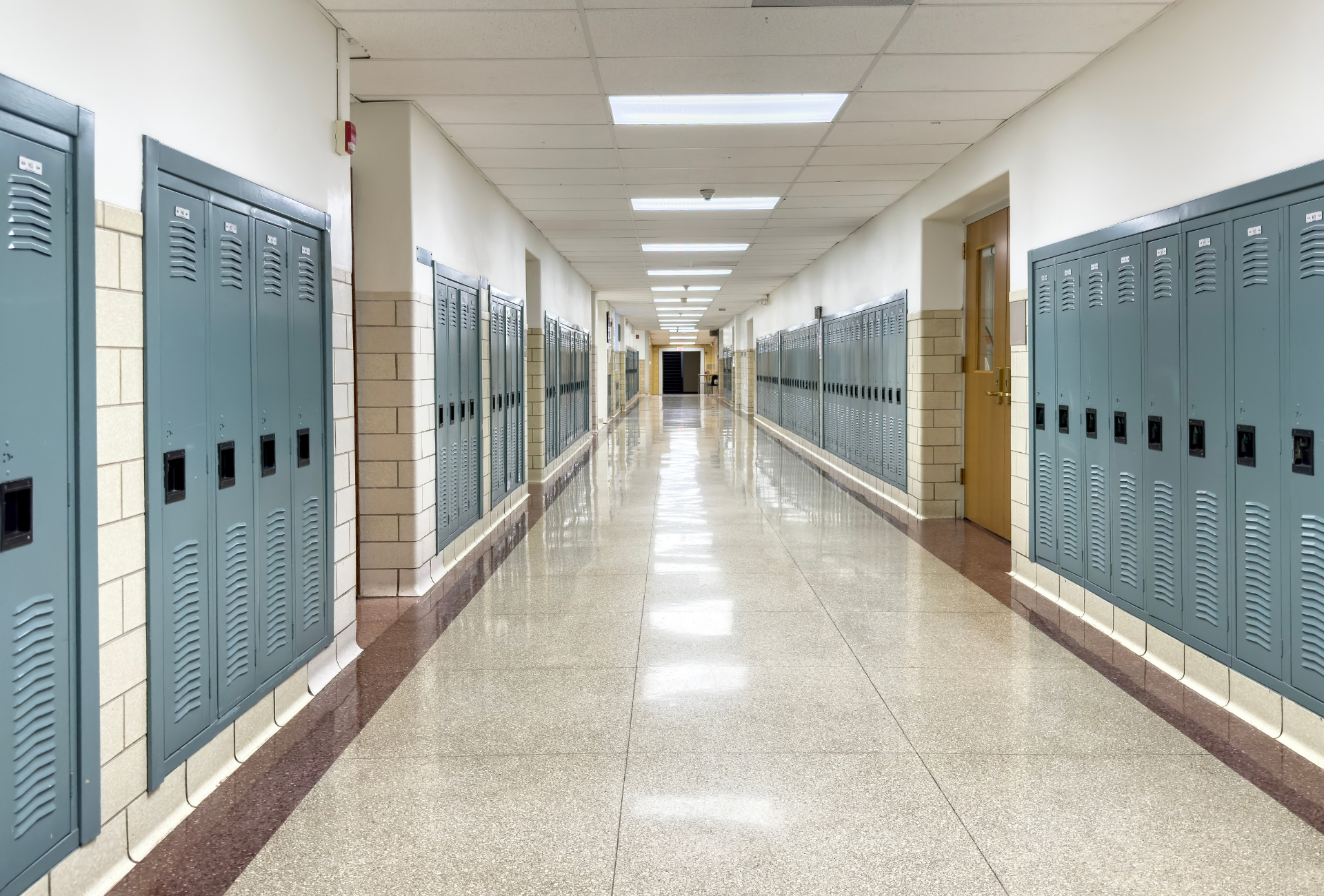 A long hallway filled with lockers in a school building.