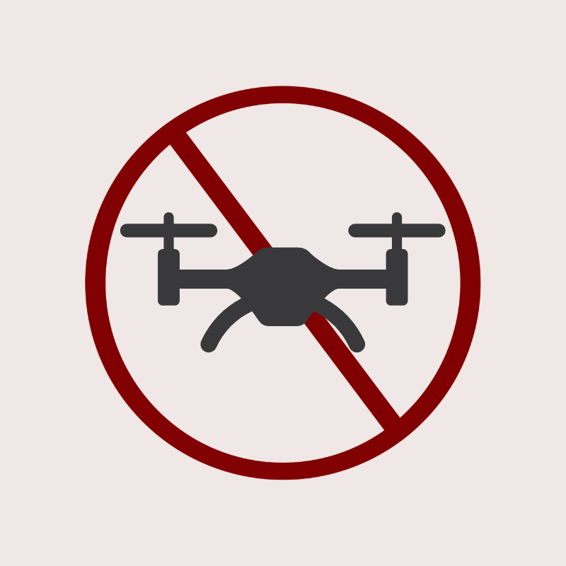 No drone symbol in a red circle with a diagonal line through it.