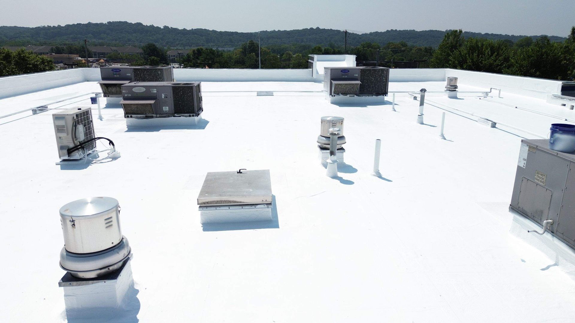 Overhead view of a corrugated metal roof on a warehouse with loading docks.