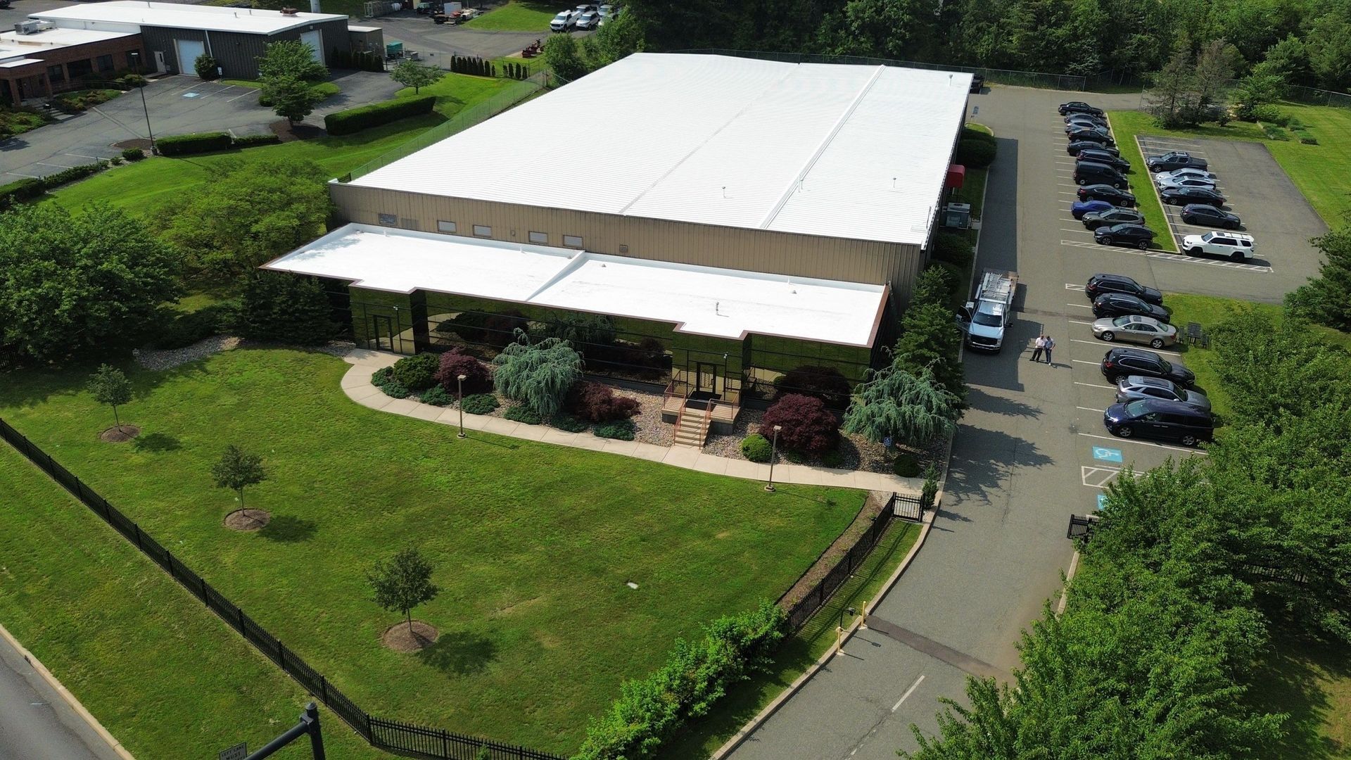 Overhead view of a corrugated metal roof on a warehouse with loading docks.