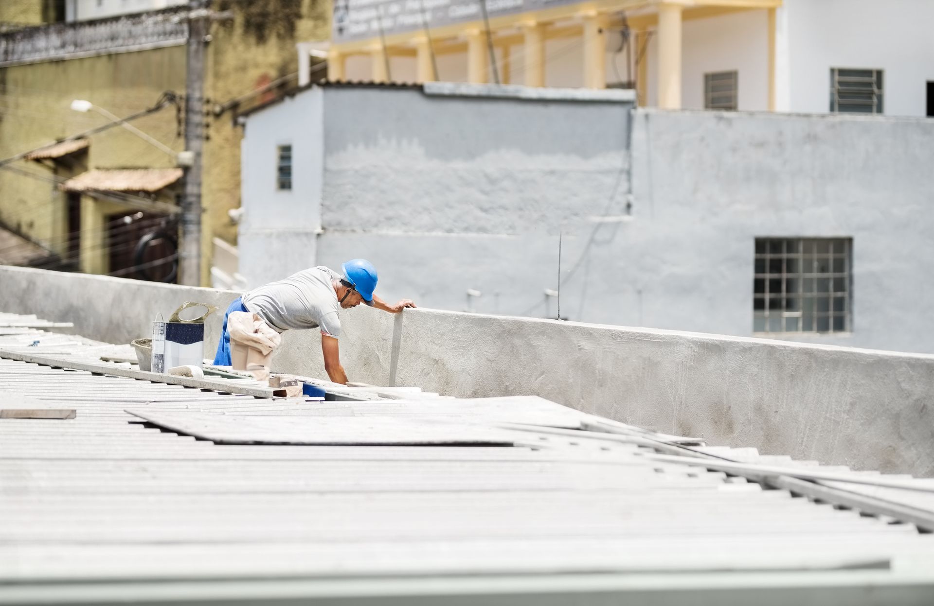 A Man Is Painting A Wall On The Roof — Mohnton, PA — Meadow Springs
