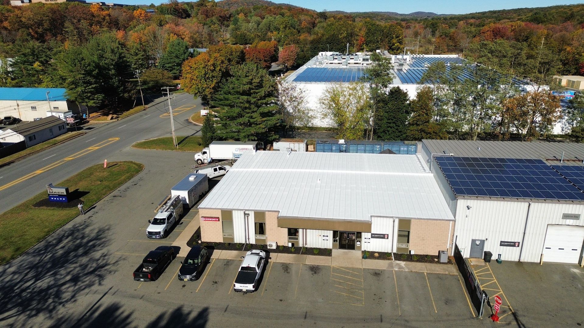 Overhead view of a corrugated metal roof on a warehouse with loading docks.
