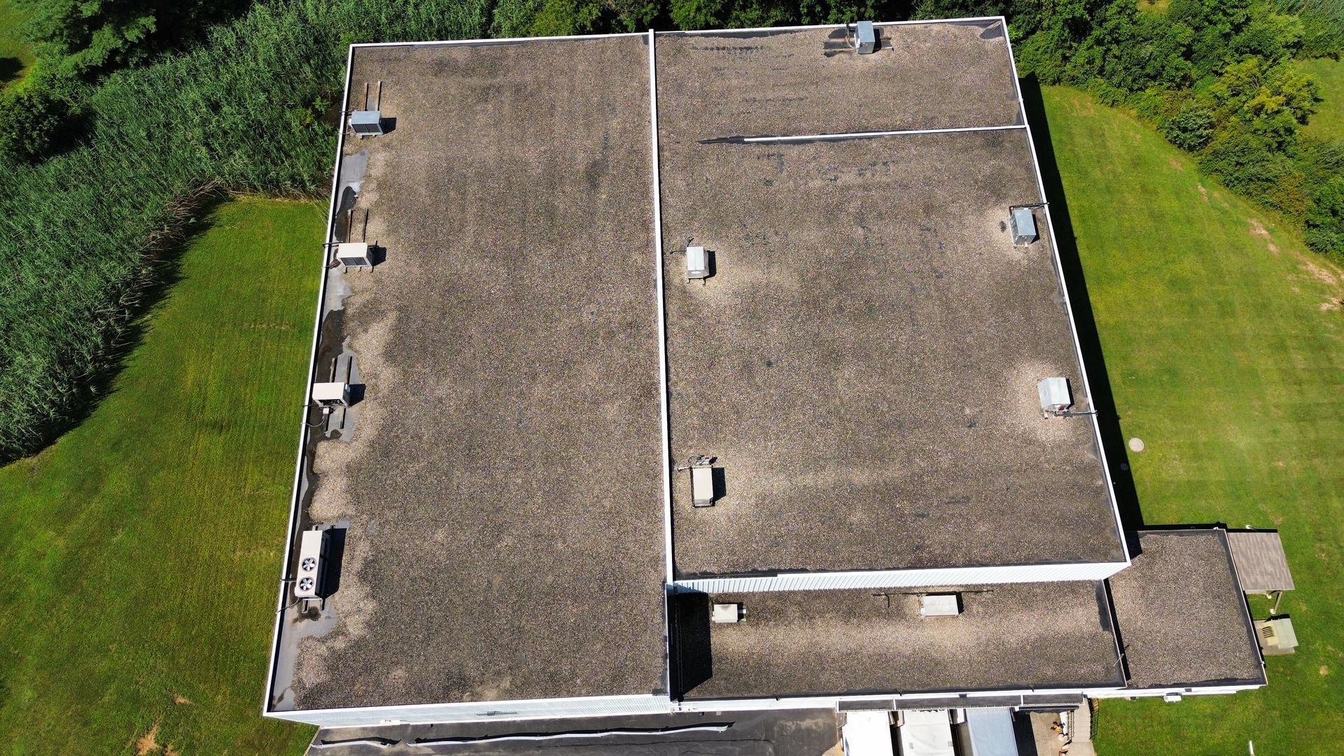 An aerial view of a large building with a roof that is covered in shingles. | Mohnton, PA | Meadow Springs