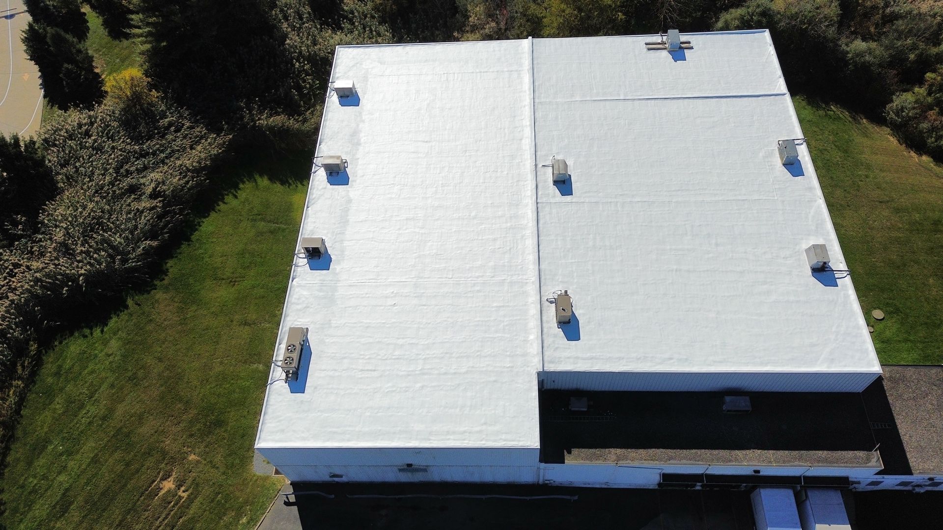 An aerial view of a large white building with a white roof. | Mohnton, PA | Meadow Springs