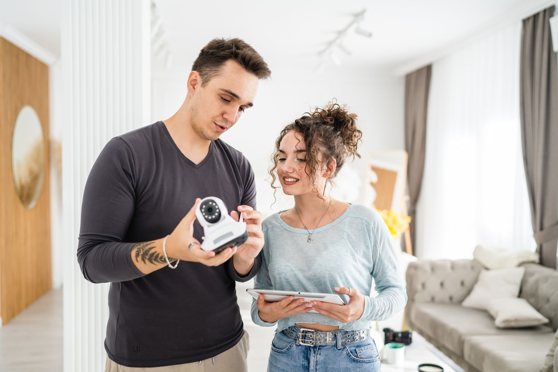 A couple set up a surveillance security camera at home. 