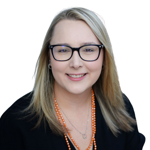 A woman wearing glasses and an orange necklace smiles for the camera