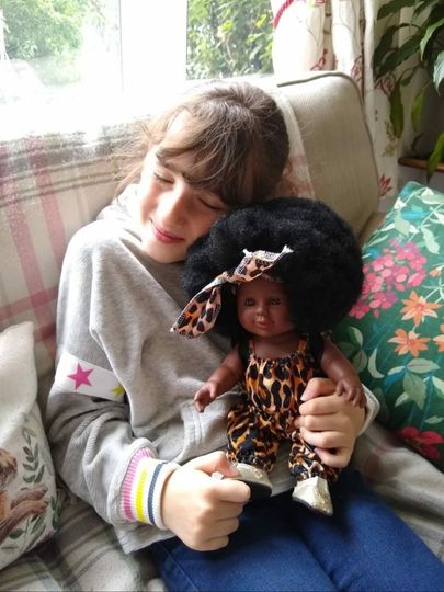 Girl cuddling doll