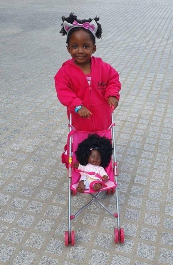 Black girl with doll
