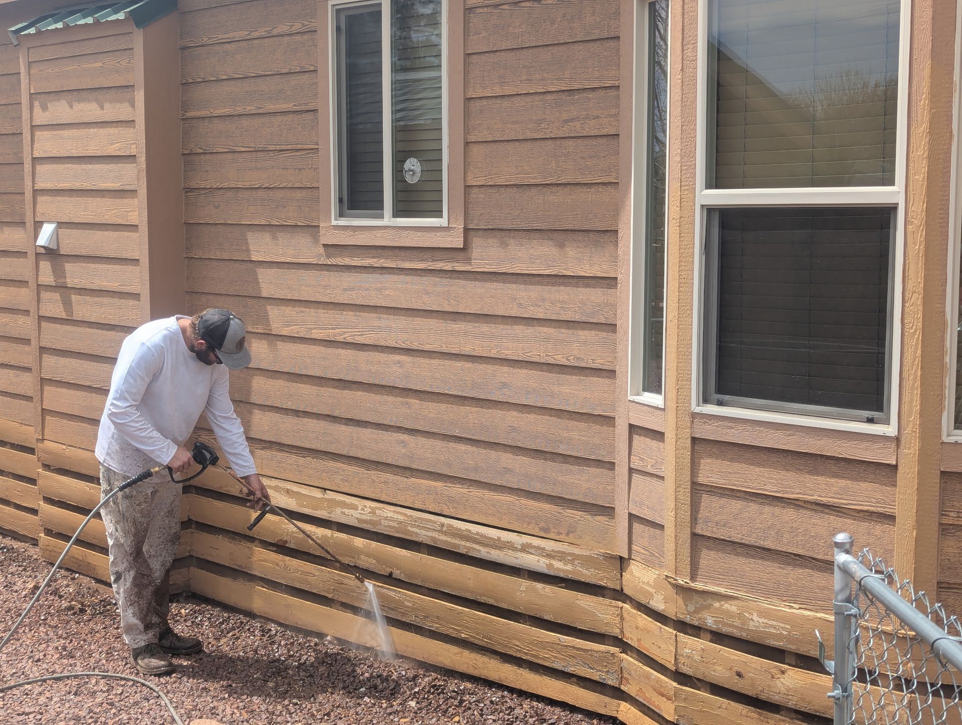 A large brick house with a gray roof and black shutters