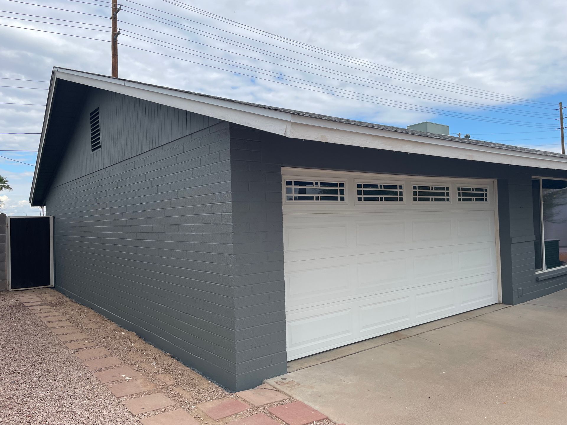 A gray house with a white garage door