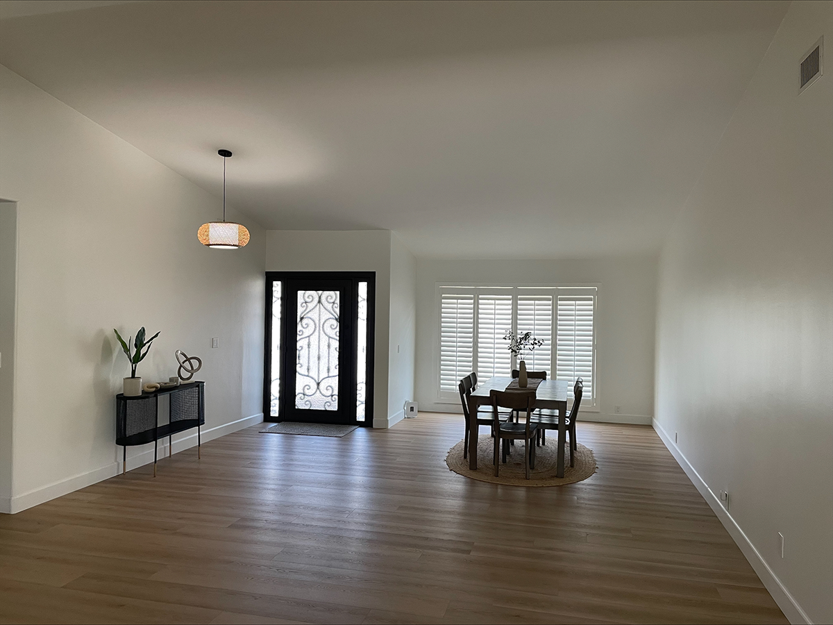 There is a dining table and chairs in the middle of the room.