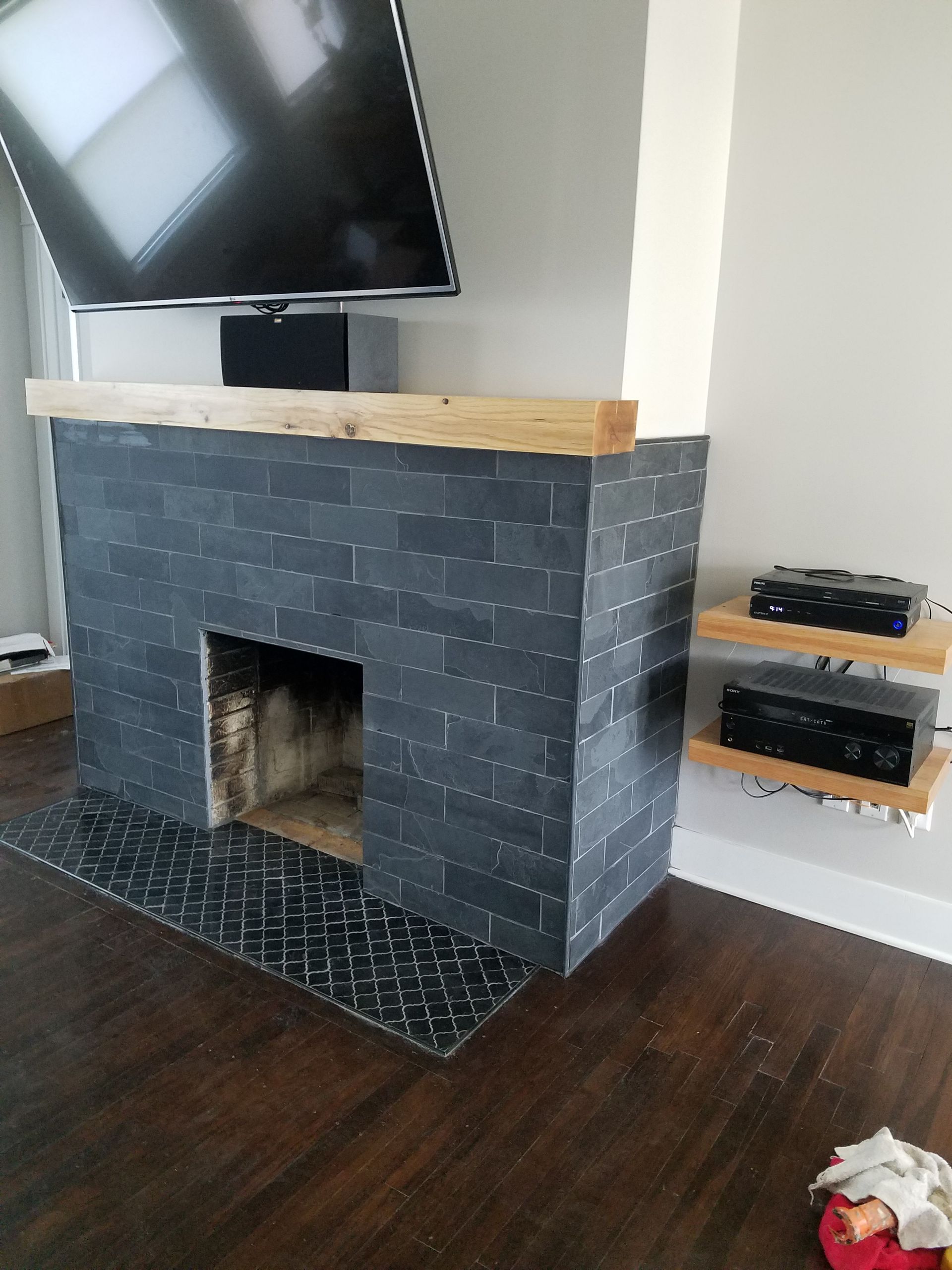 A bathroom featuring a dual-sink vanity with white cabinets, a green countertop, a large mirror, and light-green carpeting.