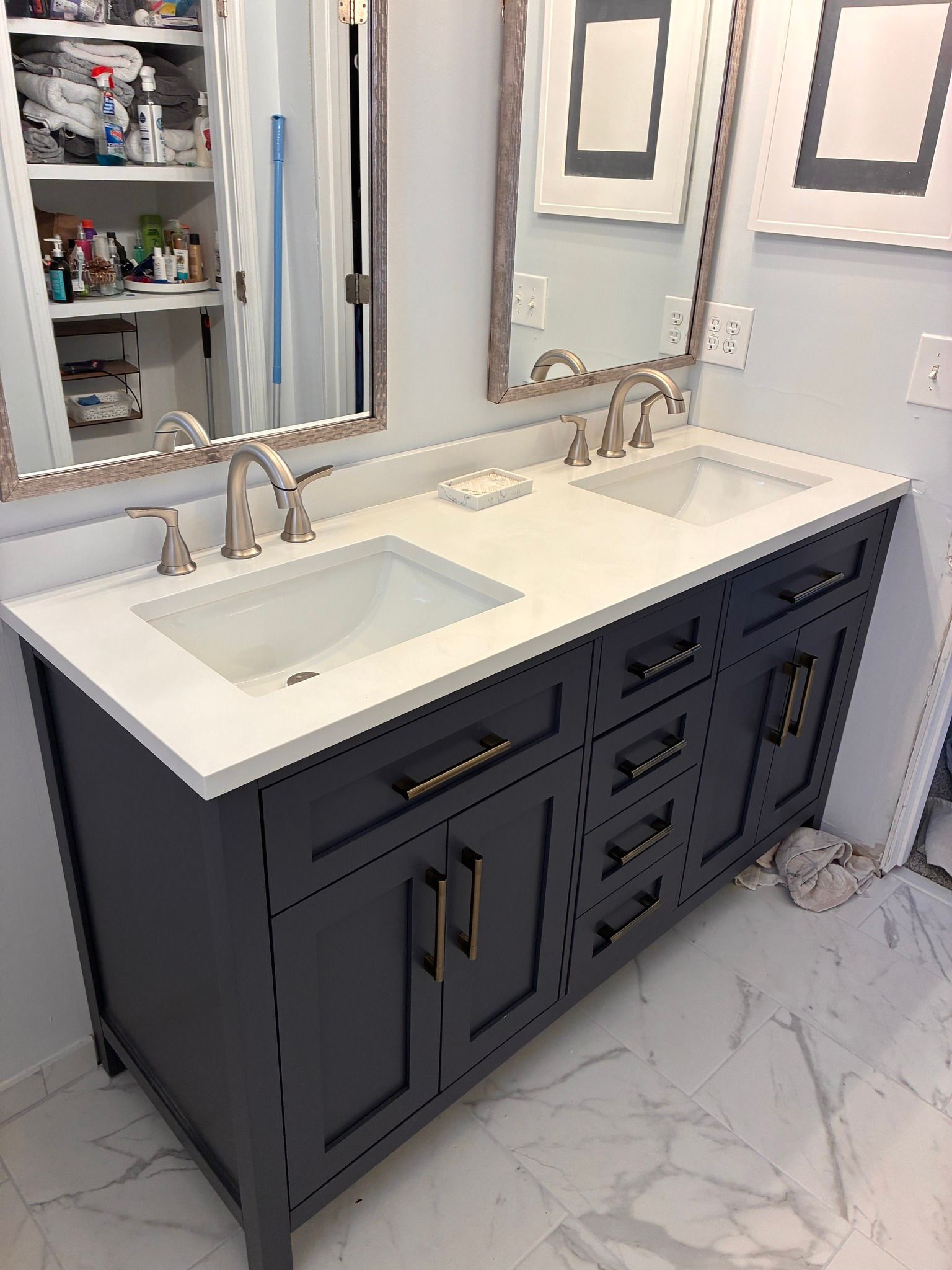 A bathroom featuring a dual-sink vanity with white cabinets, a green countertop, a large mirror, and light-green carpeting.