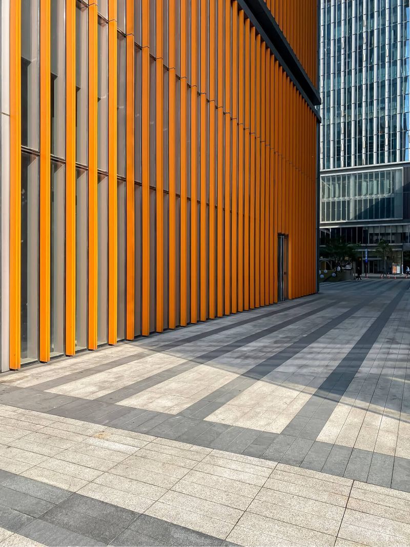 | Dianna Thompson |  A large orange building with a striped sidewalk in front of it.