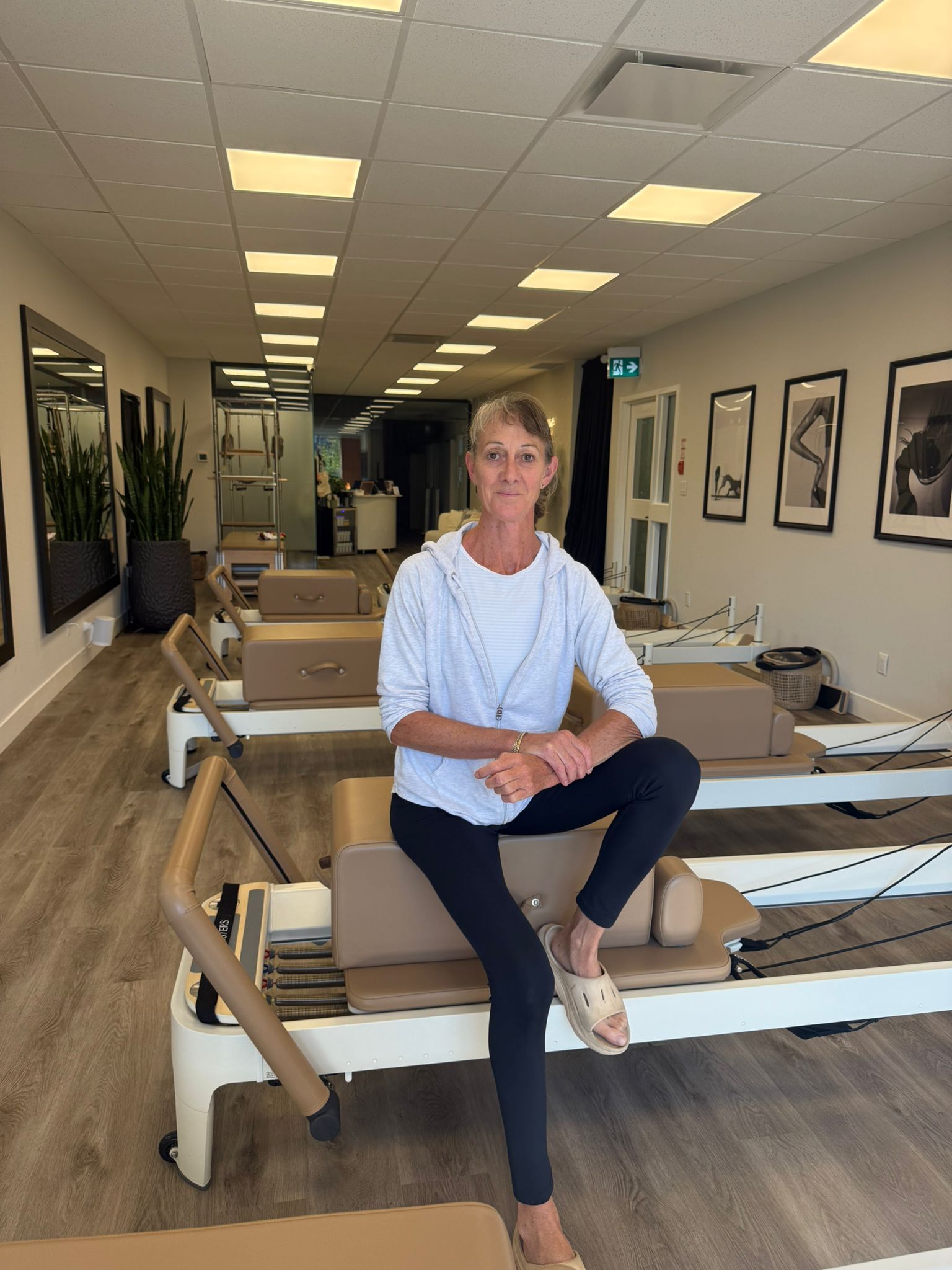 Certified Pilates instructor inside Two Sisters Pilates studio in Oakville