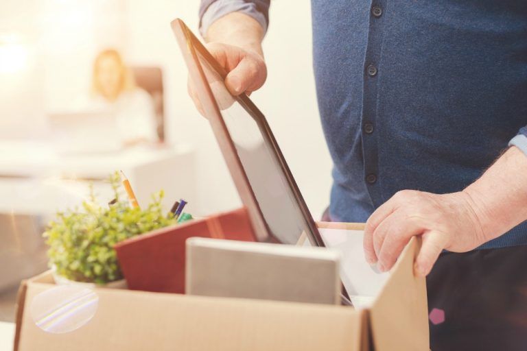 Compact cardboard moving box with flaps sealed, prepared for relocation, filled with miscellaneous items.