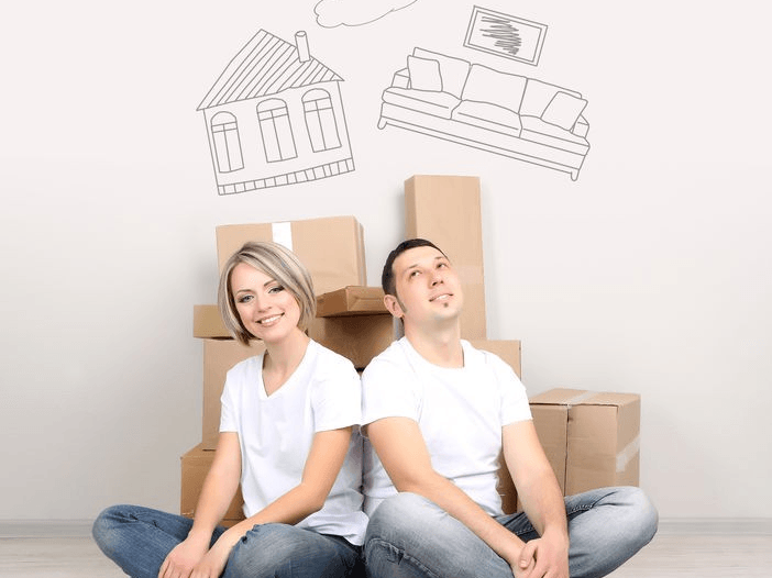 Couple Sitting In Front of Moving Boxes — Expert Removalists In The Northern Rivers NSW