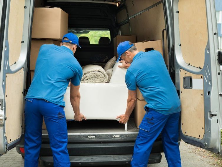 Movers Removing Couch From Truck — Expert Removalists In Byron Bay NSW