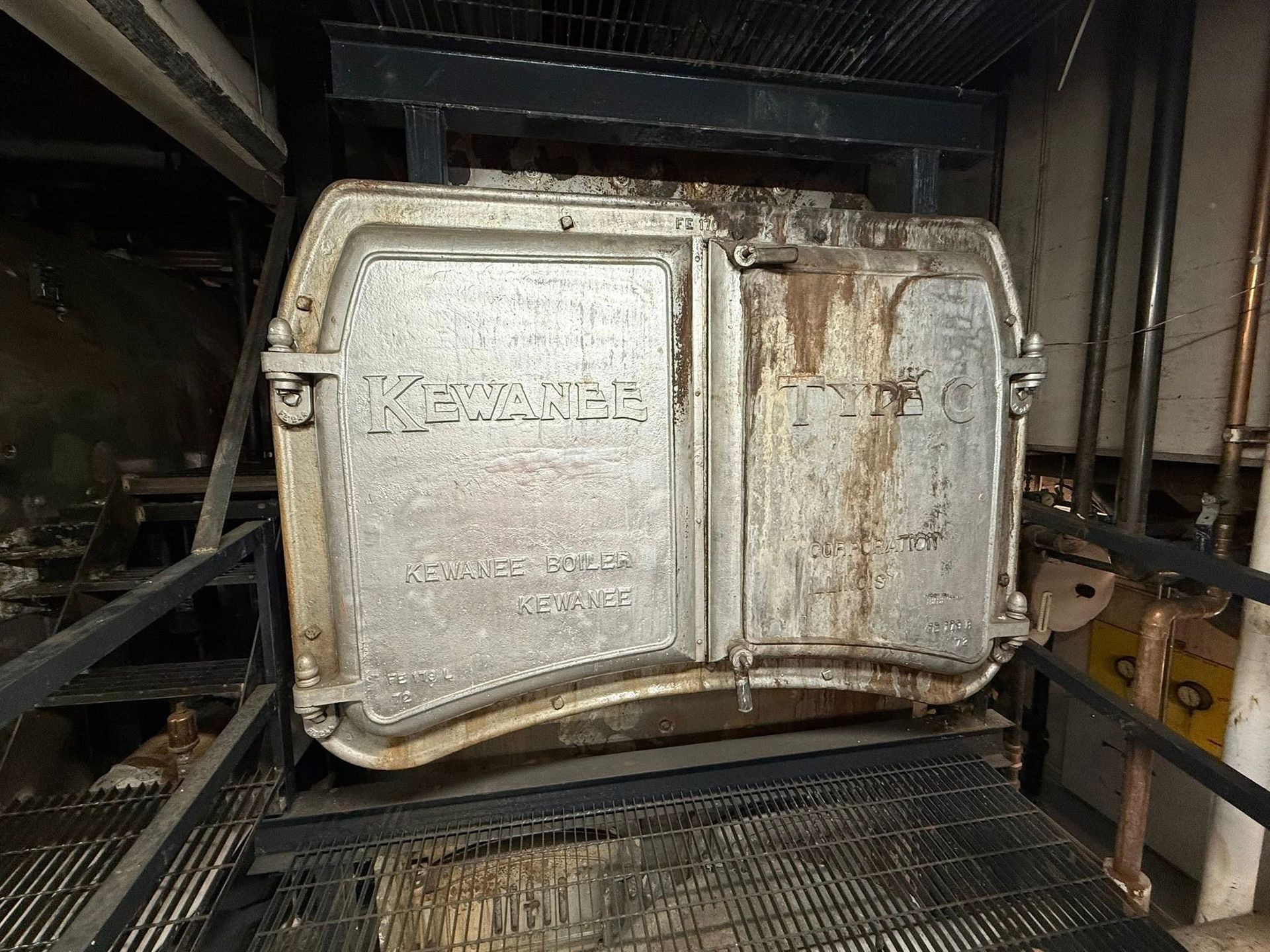 Heavy metal furnace doors with the name 