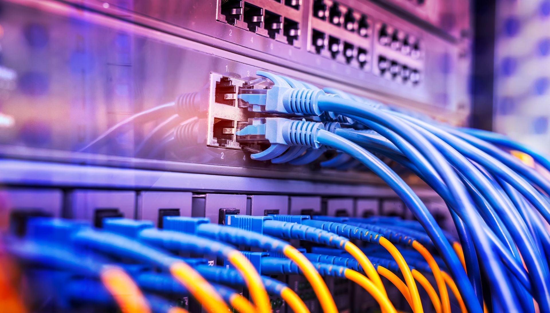 A bunch of cables are connected to a server in a data center.