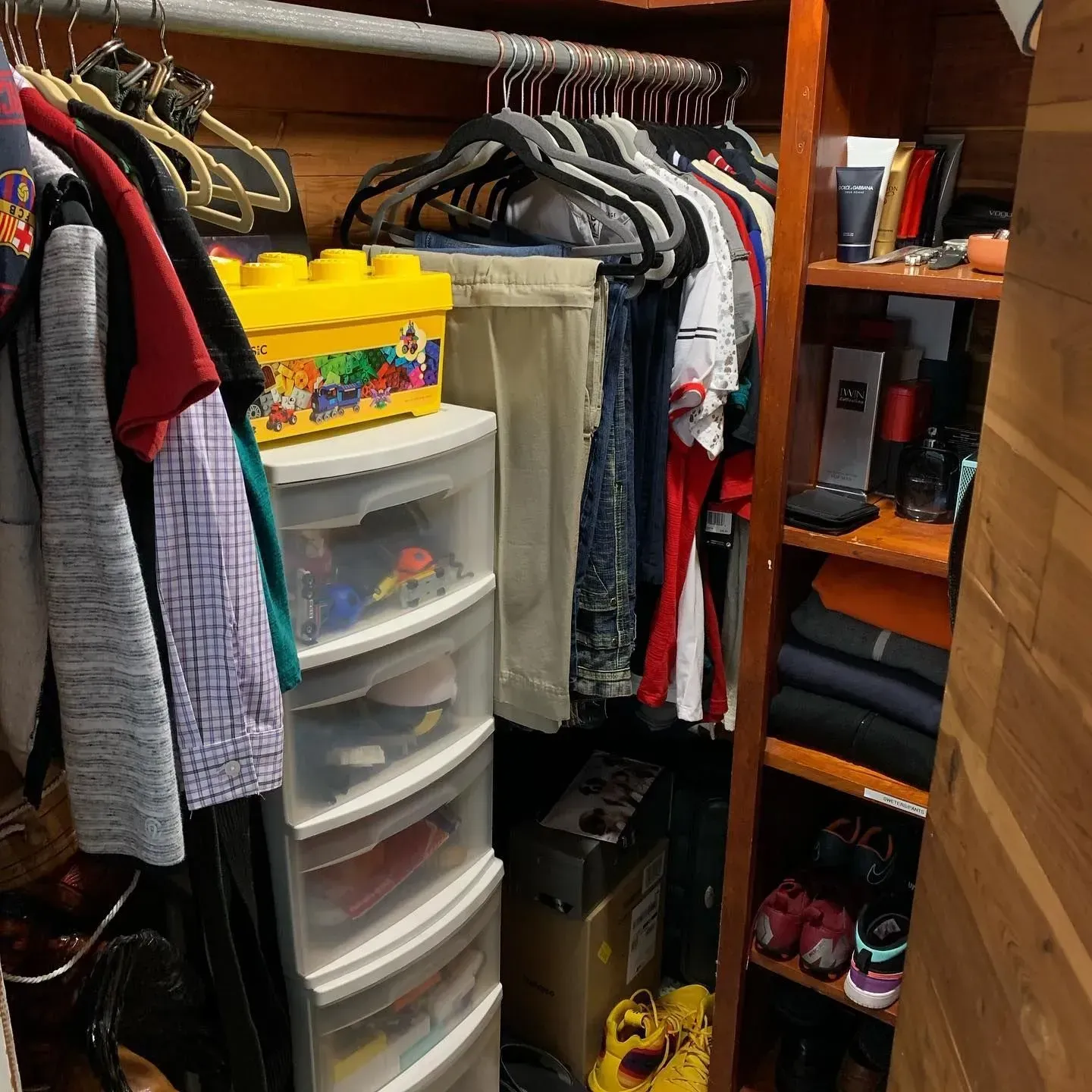 A closet filled with lots of clothes and shoes