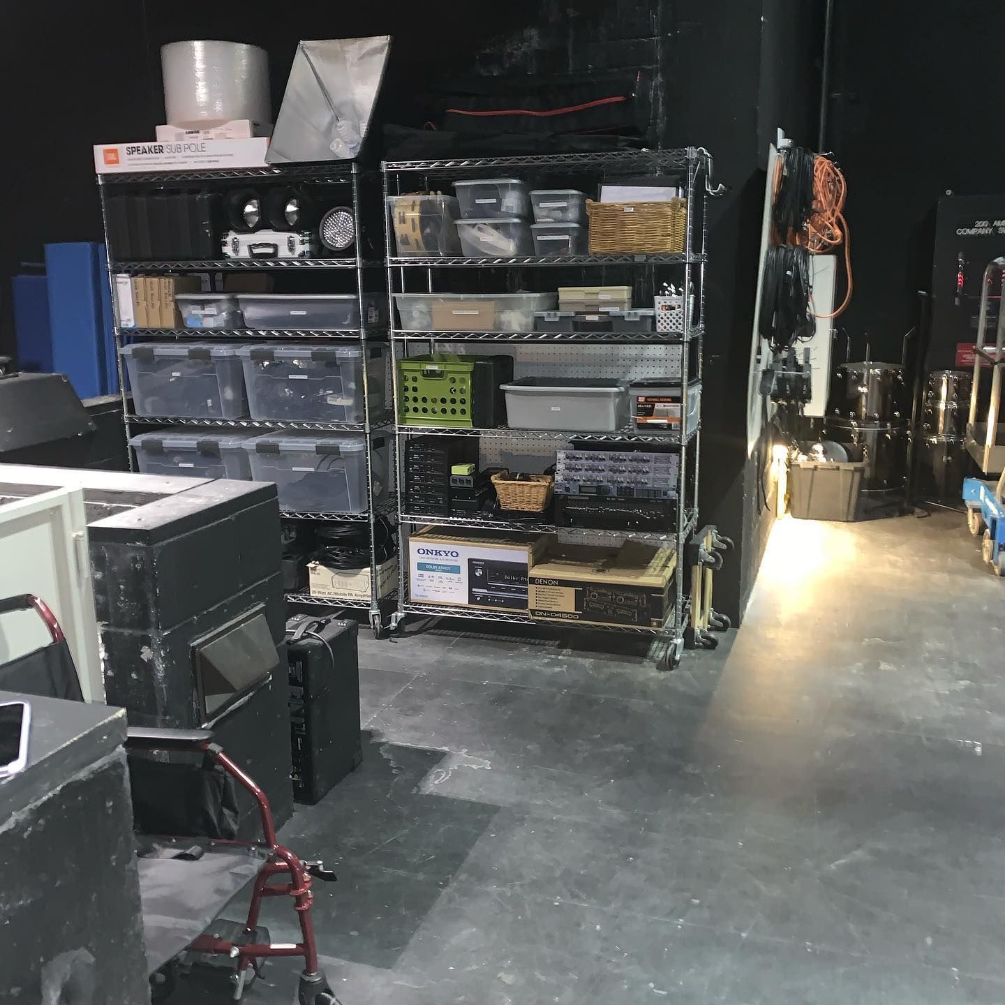 Boxes in a room, likely during a move. Fireplace and rug visible, warm sunlight shining in.