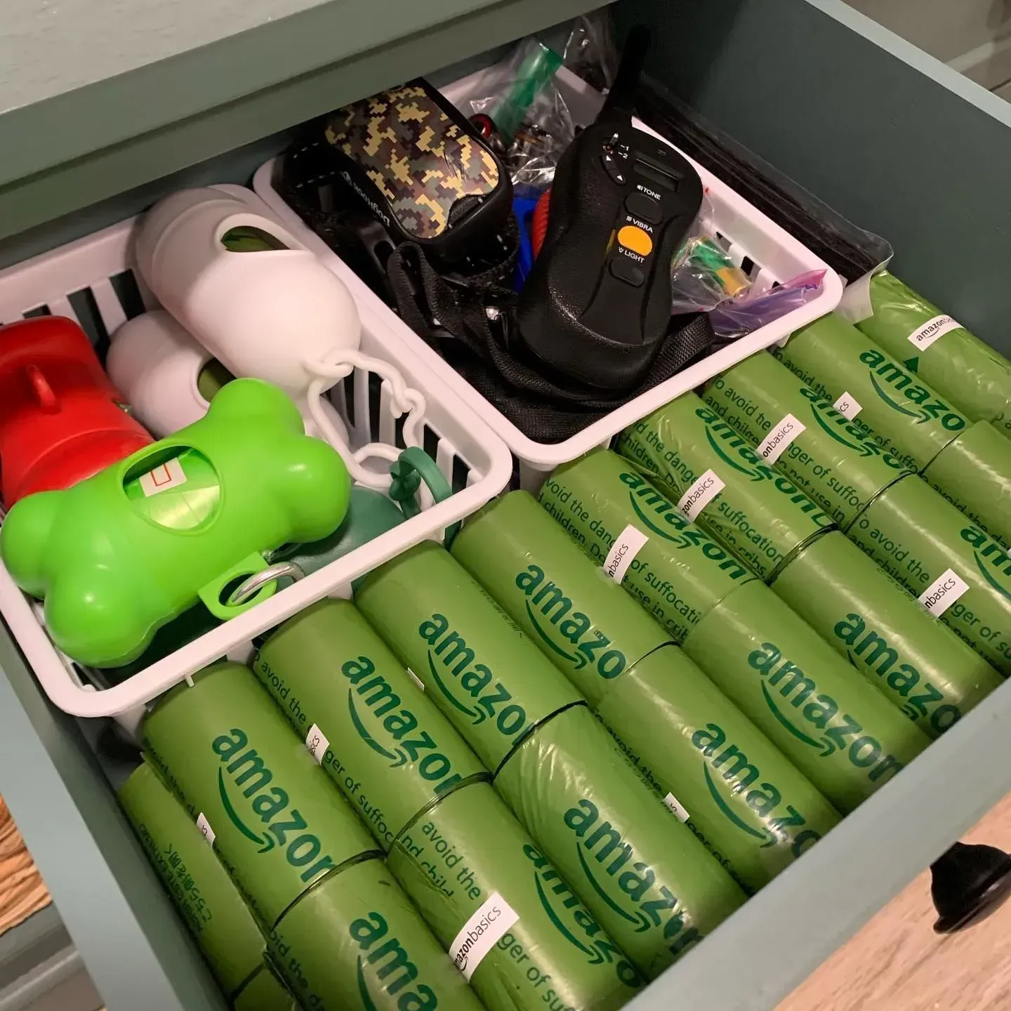 A drawer filled with green amazon bags