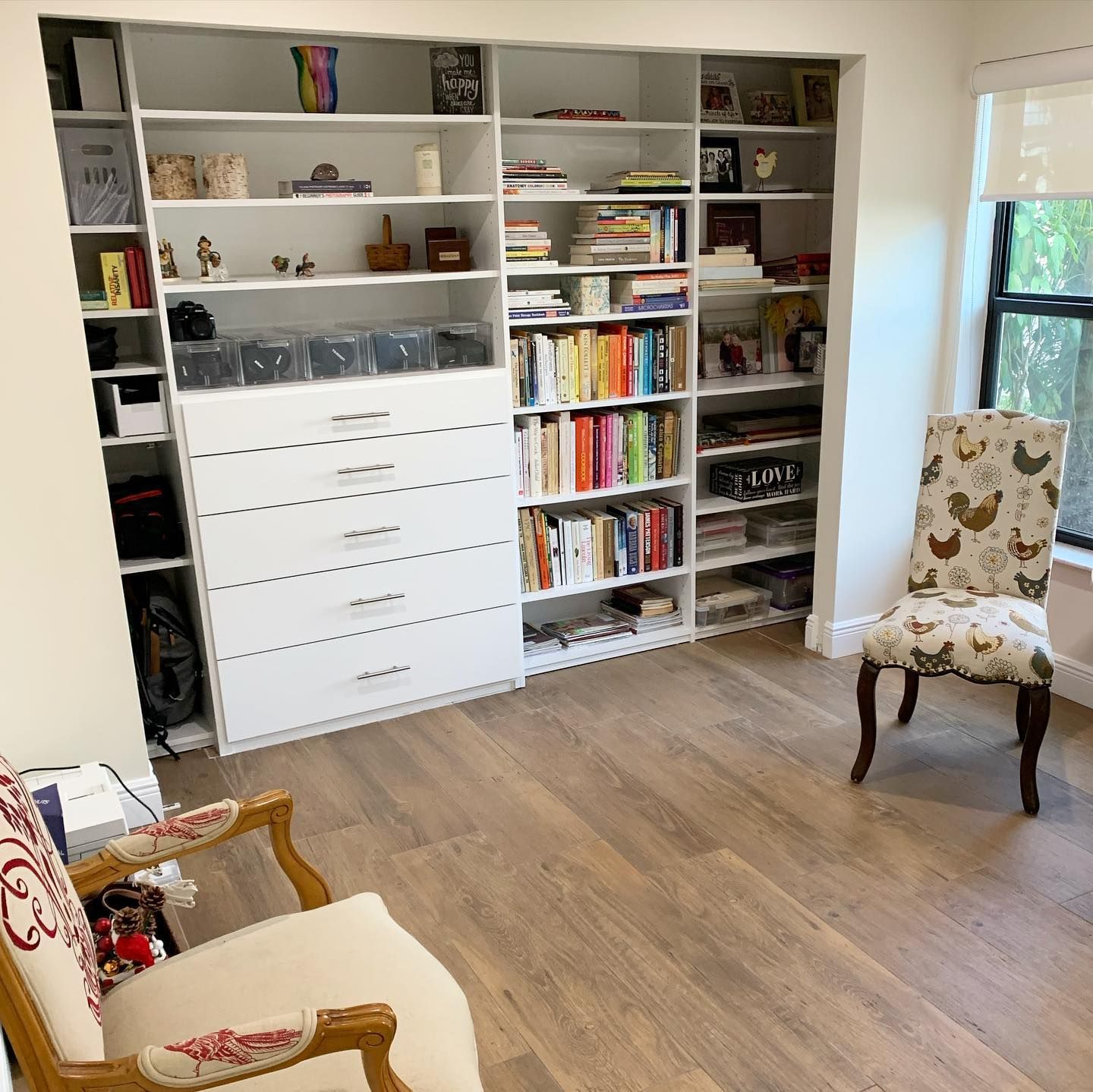 A room with lots of bookshelves and a chair