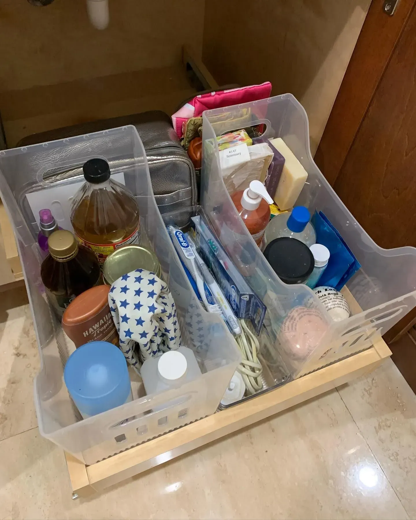 A bathroom drawer filled with lots of toiletries and bottles.