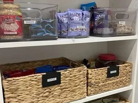 A pantry filled with lots of food and wicker baskets.