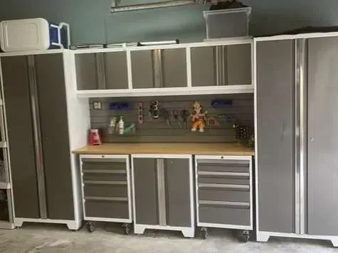 A garage filled with lots of gray cabinets and drawers.