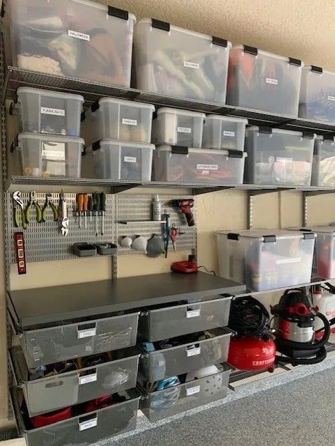 A garage filled with lots of storage bins and drawers.