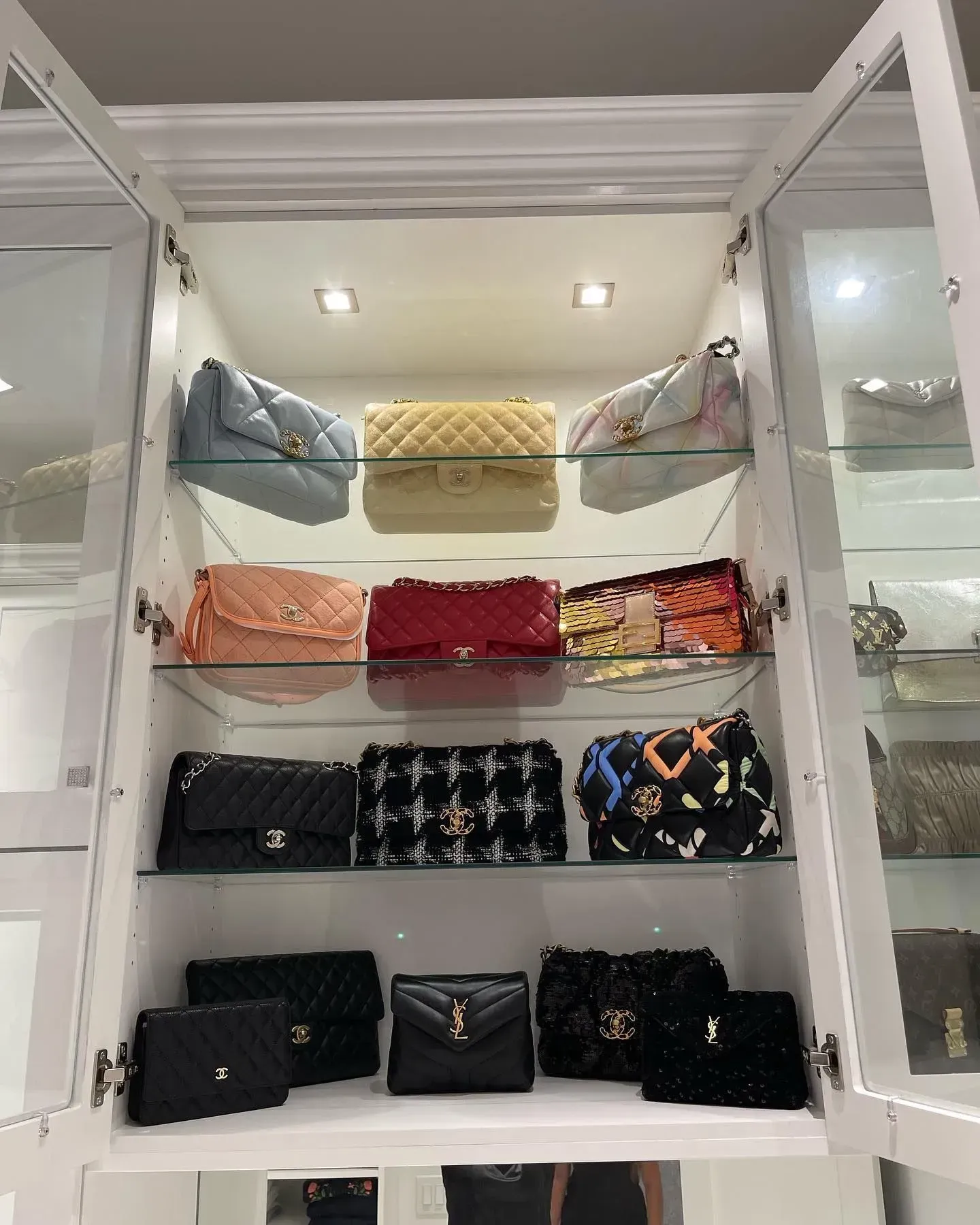 A closet filled with lots of handbags and wallets.