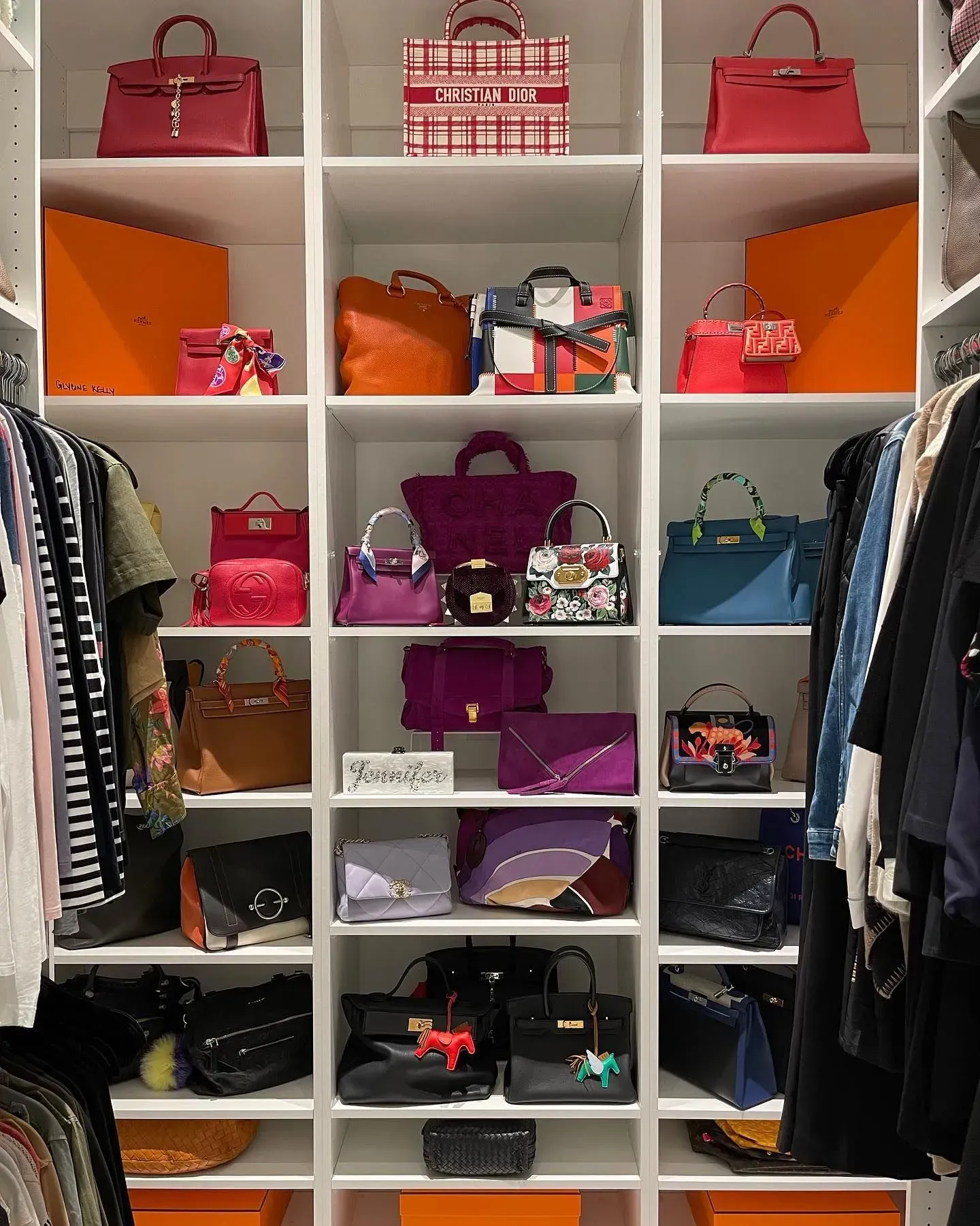 A closet filled with lots of handbags and clothes.