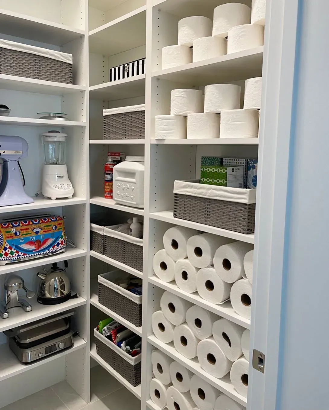 A pantry filled with lots of toilet paper and other items.