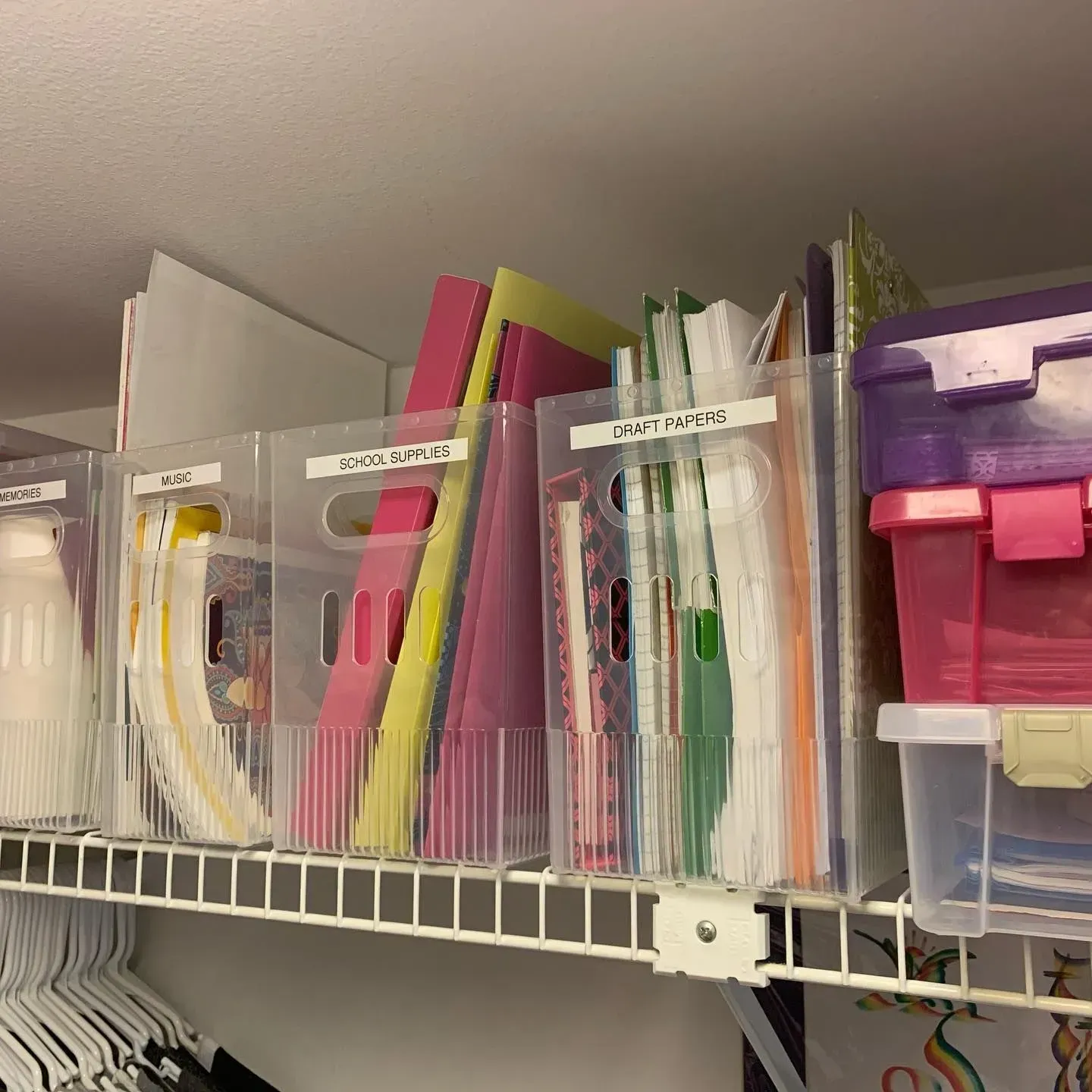 A shelf filled with lots of clear plastic bins and boxes