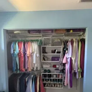 A closet filled with lots of clothes and shoes.