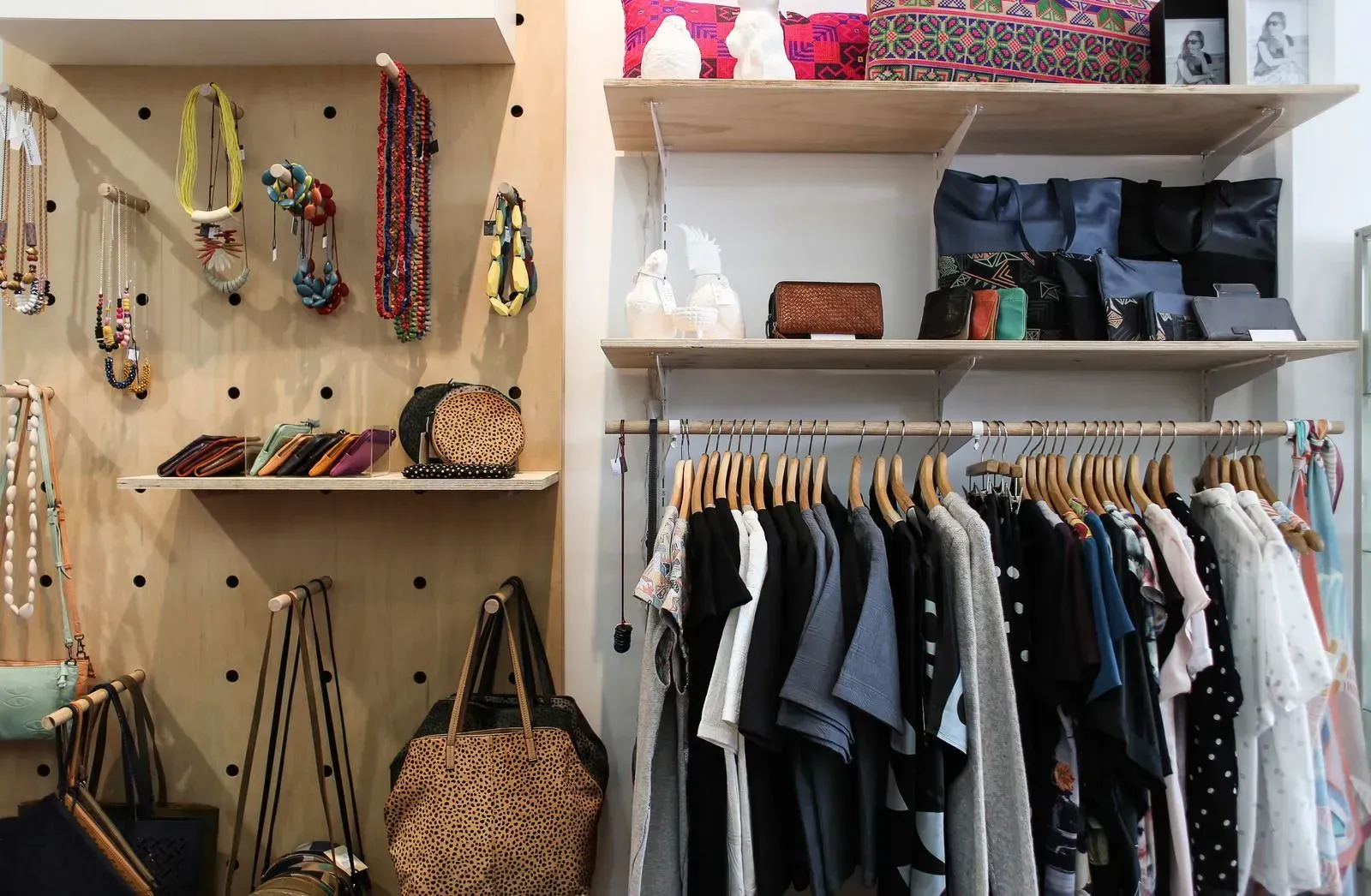 A closet filled with clothes , handbags , and jewelry.