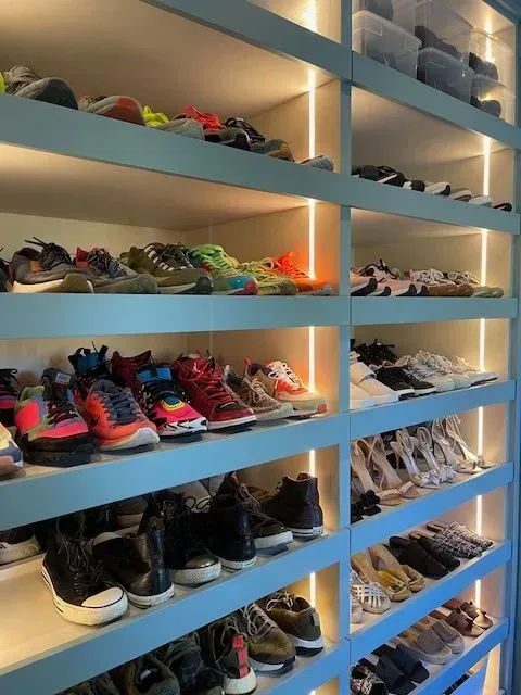 A closet filled with lots of shoes on shelves
