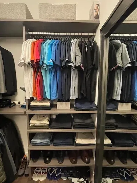 A closet filled with lots of clothes and shoes