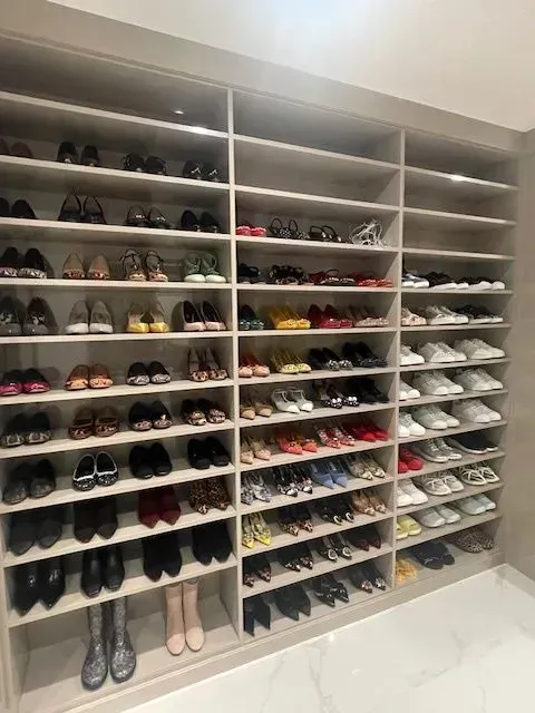 A closet filled with lots of shoes and boots