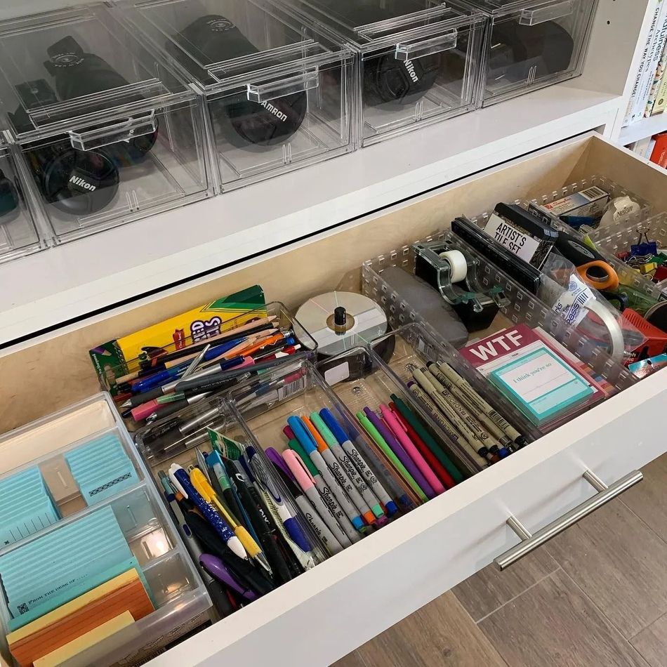 A drawer filled with a variety of office supplies.